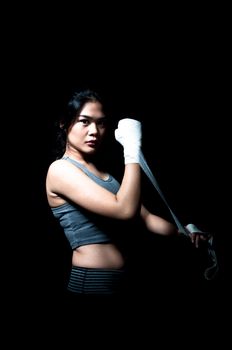 Asian female boxer on black background