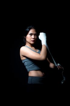 Asian female boxer on black background