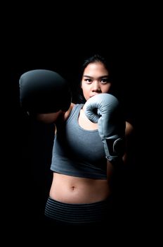 Asian female boxer on black background