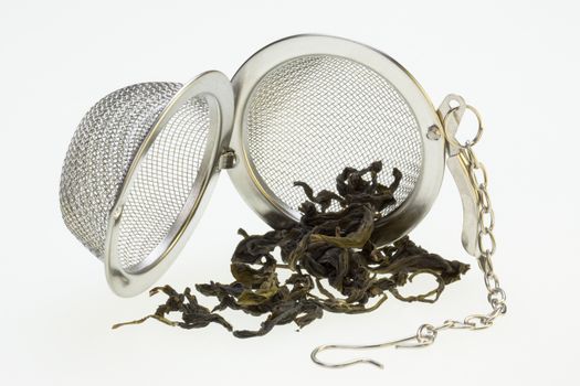 A Tea Infusing Basket or Brewing Basket and green tea.