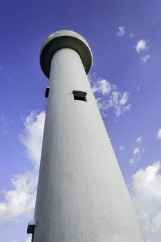 White, abandoned lighthouse in the Philippines against blue sky