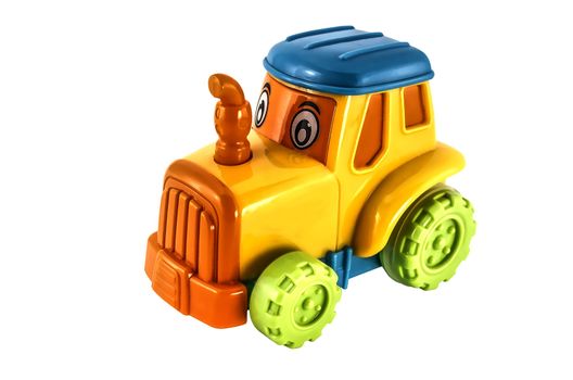 Small yellow toy tractor isolated on white