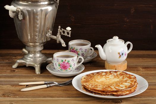 Russian bliny with vintage samovar and teaware horizontal