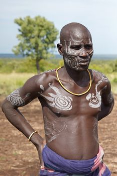 JINKA, ETHIOPIA - NOVEMBER 21, 2014: Portrait of a Mursi clan chief with traditional paintings on November 21, 2014 in Jinka, Ethiopia.