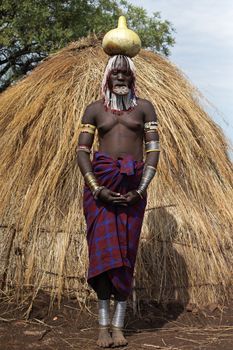 JINKA, ETHIOPIA - NOVEMBER 21, 2014: Mursi woman with traditional lip plate and tattoos on November 21, 2014 in Jinka, Ethiopia.