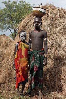 JINKA, ETHIOPIA - NOVEMBER 21, 2014: Mursi children with traditional paintings on November 21, 2014 in Jinka, Ethiopia.