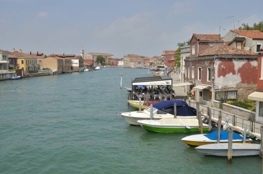 People eating in an restaurant at a canal in Murano, an island of Venice, Italy.