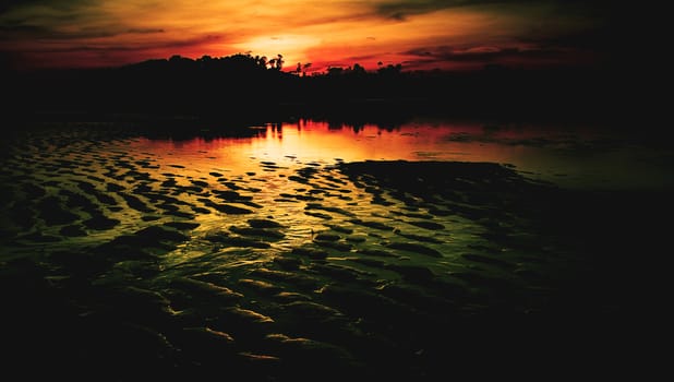 Nice sunset sky and sea at low tide in Payam island, Thailand