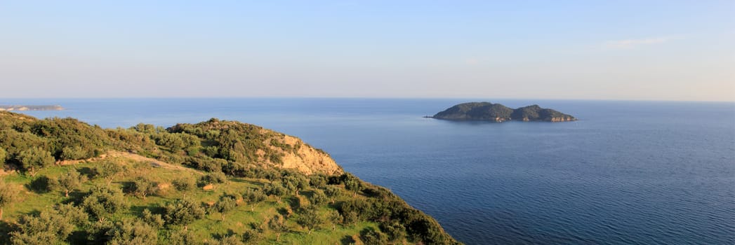 panoramic landscape of a small island and sea from a hill