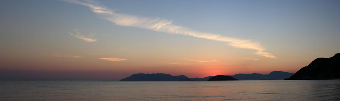 panoramic landscape of a beach at dawn with colorful sky