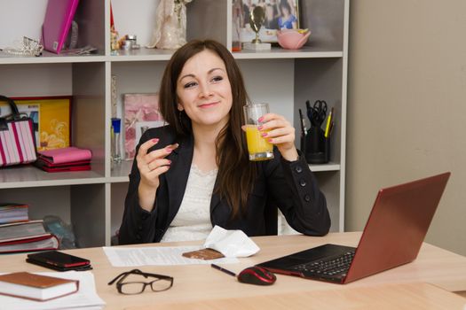 Cute business woman in the office at the computer