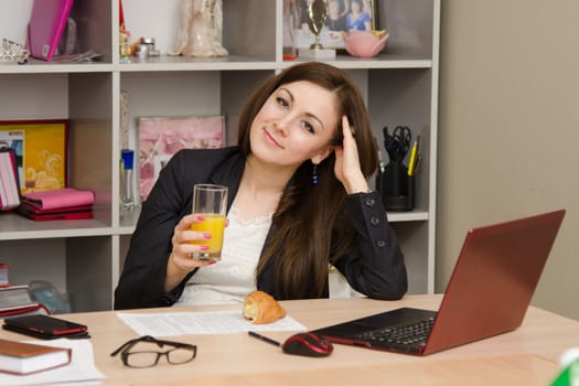 Cute business woman in the office at the computer