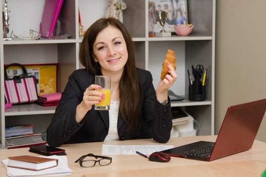 Cute business woman in the office at the computer