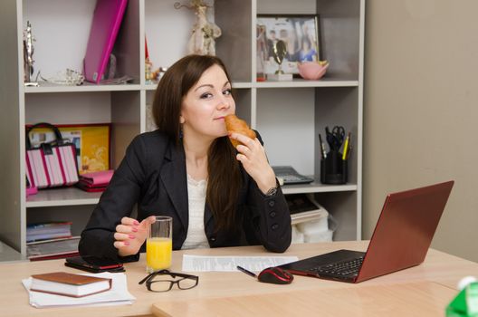 Cute business woman in the office at the computer
