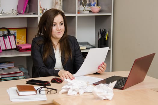 Cute business woman in the office at the computer