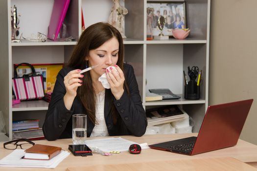 Cute business woman in the office at the computer
