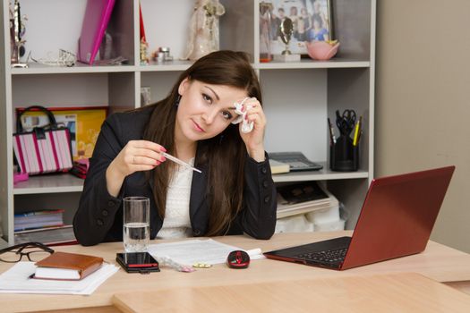 Cute business woman in the office at the computer