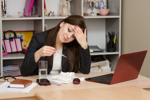 Cute business woman in the office at the computer