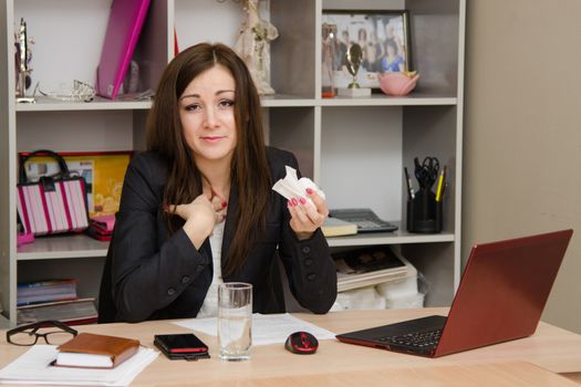 Cute business woman in the office at the computer