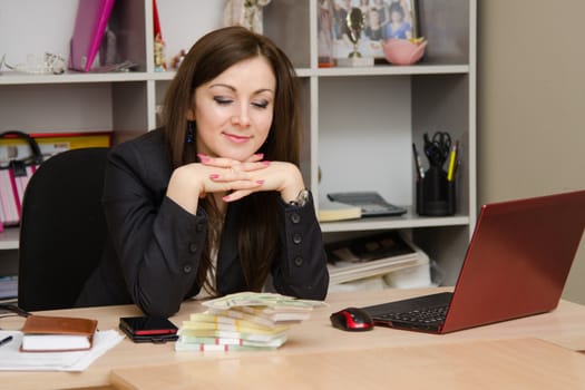 Cute business woman in the office at the computer