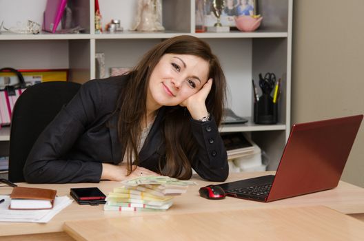 Cute business woman in the office at the computer