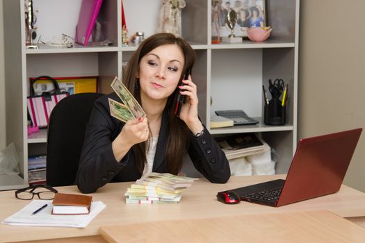 Cute business woman in the office at the computer