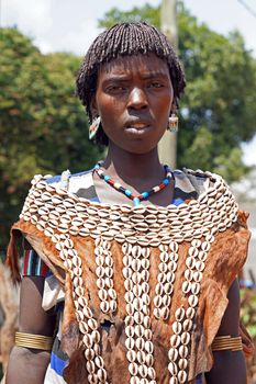 KEY AFER, ETHIOPIA - NOVEMBER 20, 2014: Young Benna girl with traditional clothings and hairstyle on November 20, 2014 in Key Afer, Ethiopia.