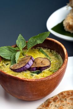 A dish of fresh Thai green curry soup with pancakes and appetizer.