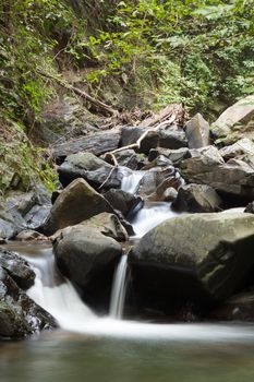 Waterfall that flows down from the mountains. Streams of water flowing down from the mountains. There is always a small stone waterfall.