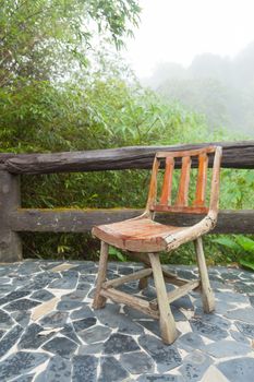 Wooden chair on the balcony. Decking made of stone The outside terrace is a tree of moist air.