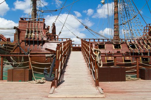 Entrance of pirate ship in park on cloudy background.