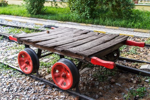 Wagonette on railway with red wheels.