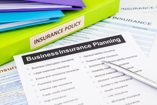 Business insurance planning checklist with documents and binders, concept for risk management