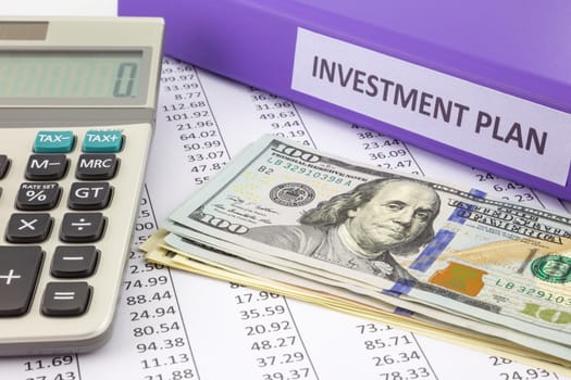Money place on financial report with purple binder of investment plan,  concept for saving fund and return on investment