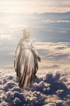 Bronze sculpture of Holy Virgin Mary in clouds.