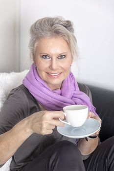 An image of a best age woman with a cup of coffee