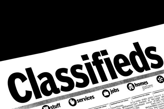 Classified advertising in a local newspaper offers available jobs in the local area.