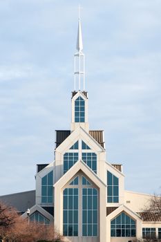Very large modern church building exterior with tall steeple.
