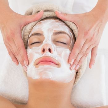 Close-up of an attractive young woman receiving treatment at spa center