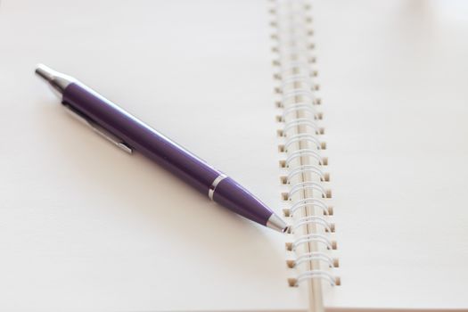 Pen and blank spiral notebook, stock photo