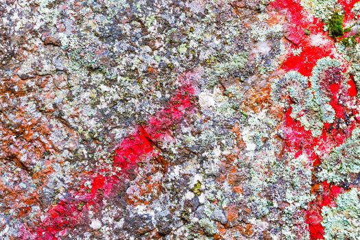 Natural colorful rock background with red paint