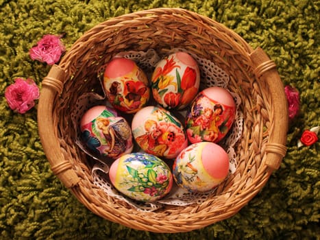 Easter eggs depicting flowers and butterflies in a wicker vase