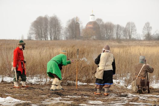 Men wearing folk costumes and masks during winter carnival Maslenitsa 2015,, in Russia