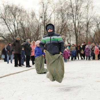 Boys sack-racing during winter Maslenitsa 2015,  carnival in Russia