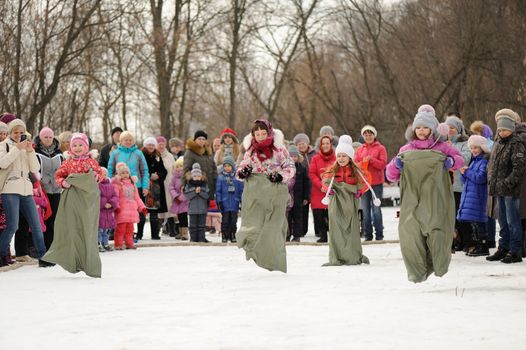 Sack-race during winter Maslenitsa 2015,  carnival in Russia