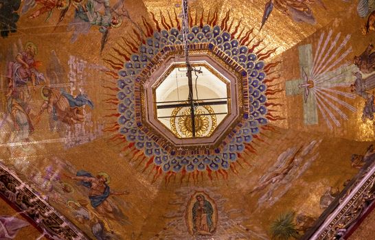 Dome Chandelier Mosaics Old Basilica Guadalupe Mexico City Mexico. Also known as Templo Expiatorio a Cristo Rey.  Basilica construction was started in 1531, finished in 1709.  This is the basilica is the location where the Virgin Mary appeared to the Meixcan peasant Juan Diego.  The old Basilica is where Juan Diego's original cloak with the picture of the Virgin Mary first appeared. 