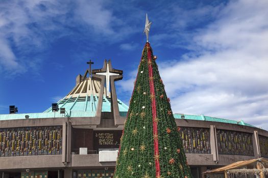 New Basilica Christmas Tree Shrine of the Guadalupe Mexico City Mexico. Also known as Basilica de Nuestra de la Senora Guadalupe.  Basilica construction was started in 1972, finished 1974.  This basilica is the location where the Virgin Mary appeared to the Meixcan peasant Juan Diego and where Juan Diego's original cloak with the picture of the Virgin Mary is located.  