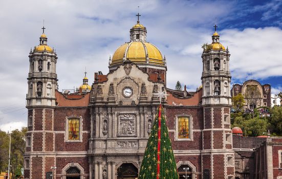 Old Basilica Christmas Tree Shrine of the Guadalupe Mexico City Mexico. Also known as Templo Expiatorio a Cristo Rey.  Basilica construction was started in 1531, finished in 1709.  This is the basilica is the location where the Virgin Mary appeared to the Meixcan peasant Juan Diego.  The old Basilica is where Juan Diego's original cloak with the picture of the Virgin Mary first appeared. 