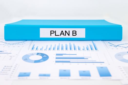 Blue document binder with PLAN B word place on graphs and charts of business plan, solution for project management