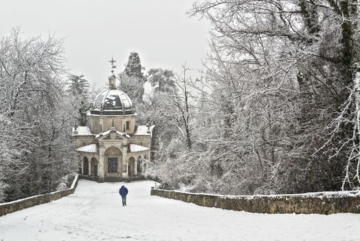 Man walking on the path in a snowy afternoon, Sacred Mount of Varese